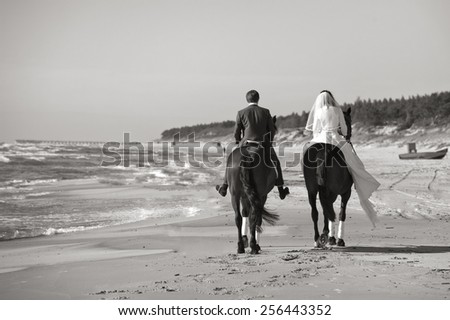 Happy newlyweds rode along the sea. Black white
