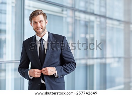 Portrait of a stylish corporate executive smiling confidently at the camera
