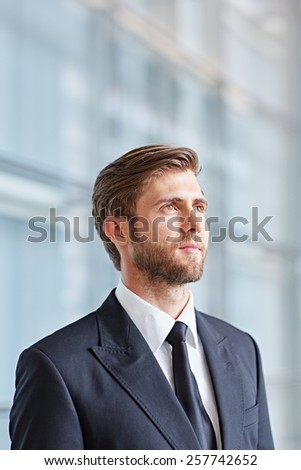 Portrait of a corporate executive looking up thoughtfully and confidently