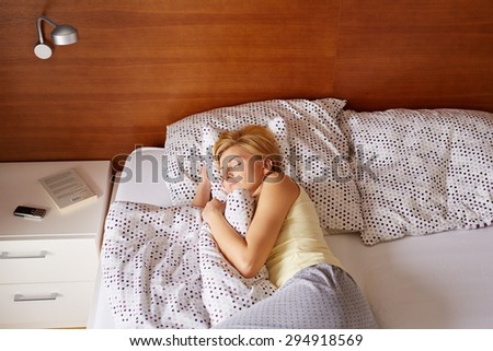 A young woman asleep in her bed