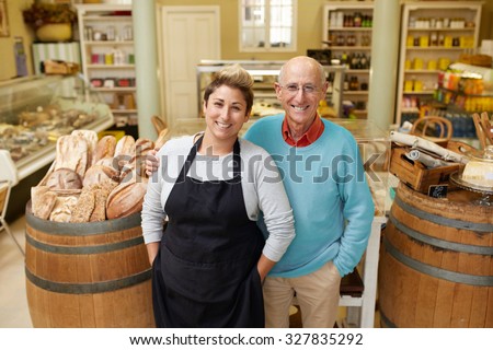 A father and daugther standing together in their deli