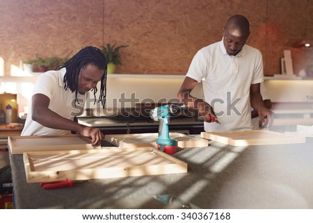 African carpenters making frames in their workshop