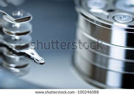 Hard disk drive, detail. Close up shot of hard disk\'s head, blue, Information Technology