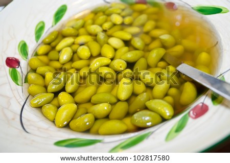 Green olives at restaurant\'s brunch in decorated plate