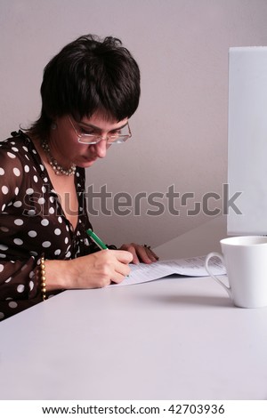 Woman in the office filling in the application form