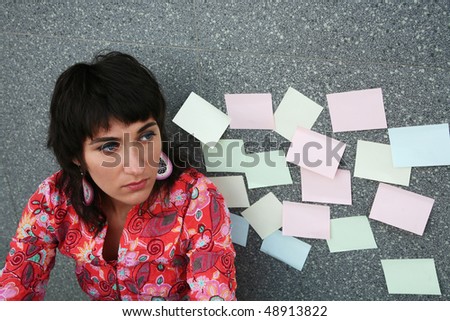 Young woman against the wall with stickers