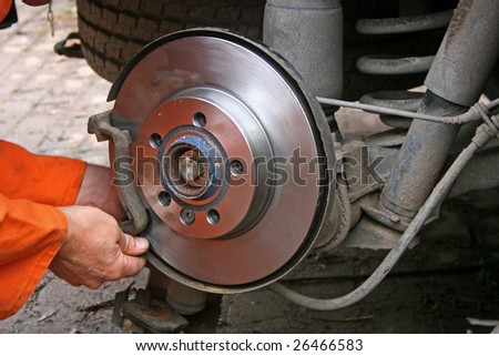 mechanic changing brake disc