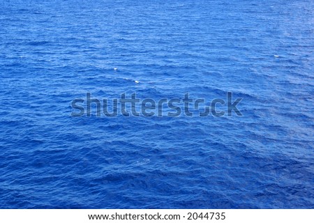A clear shot of wide open ocean water. Great background picture.