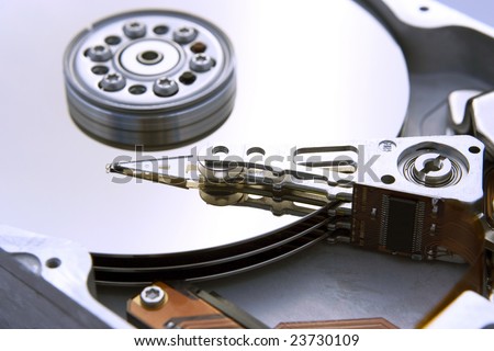 An opened computer hard drive exposing the inside discs.