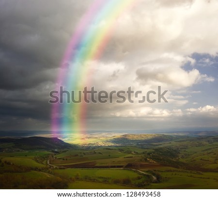 summer landscape with rainbow and clouds