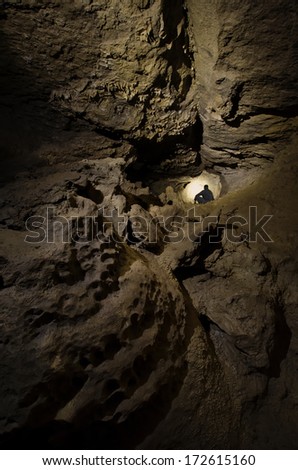 man at entrance of dark cave