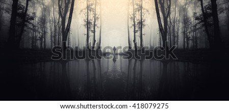 forest with reflection in lake and man silhouette
