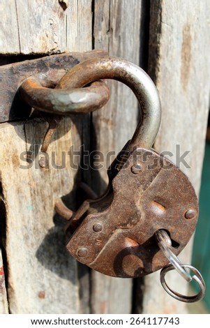 Old rusty door lock with a large key.