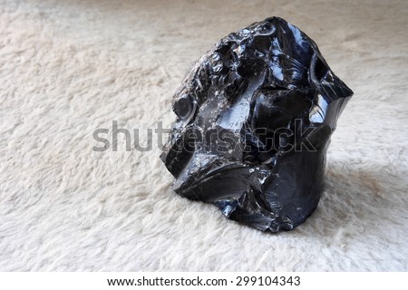 Obsidian stone from a free beach of the Lipari island , one of the Aeolian Islands in Sicily, Italy.
