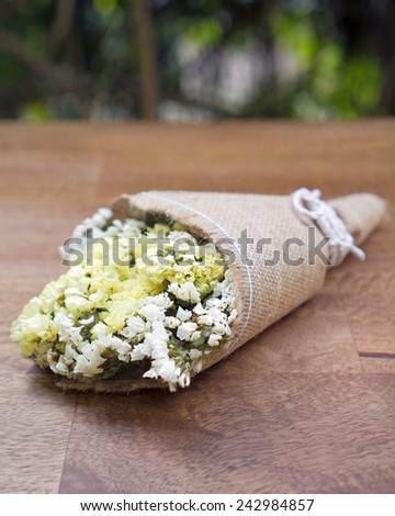Dried flower bouquet on wooden table