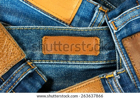 Jeans with brown leather labels texture and background
