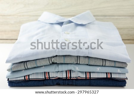 Stack of clothes closeup with white wood background