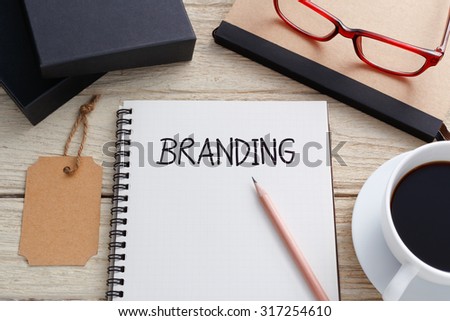 Branding concept with notebook, brand tag and product box and coffee on work desk