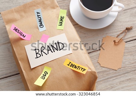 Branding marketing concept with kraft paper bag, brand tag and coffee cup