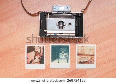 Barcelona, Spain. 6 April 2015.Old fashioned Polaroid camera with instant photos around it.