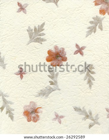 Section of textured handmade paper with flowers and leaves embedded in it