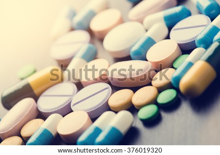 Pharmacy background on a black table. Tablets on a black background. Pills. Medicine and healthy. Close up of capsules. Different kind of medicines