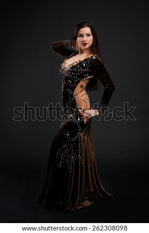 woman dancing oriental dance in a luxury chocolate suit