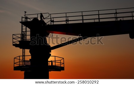 Port crane in sunset light.
