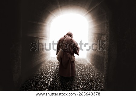 blissed Friar with faith on god walking toward the light