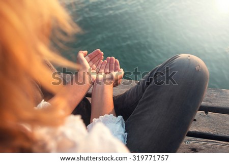 calm woman meditating reciving light energy with hands