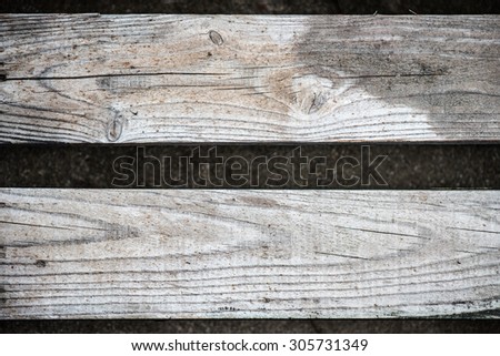 Two wood slats parallel on ground