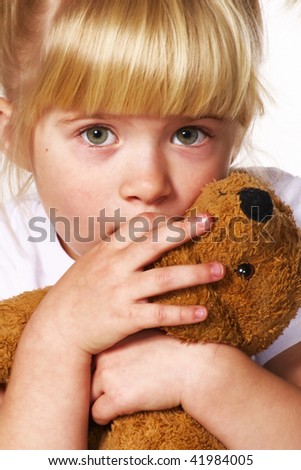 little scared girl with puppy toy