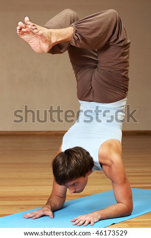 young man doing yoga indoor