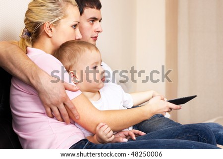 family in living room with remote control