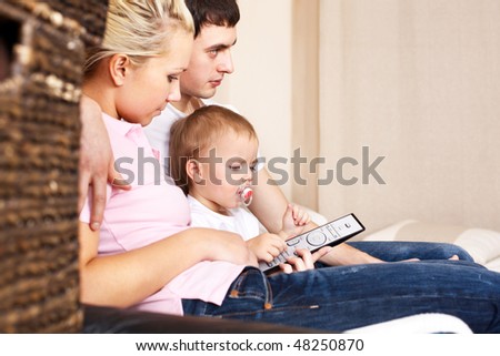 family in living room with remote control