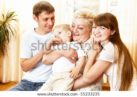 mother, father and grandmother playing with child indoor