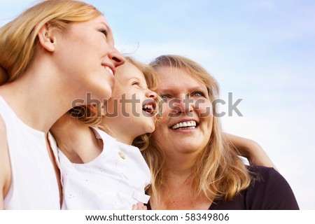 happy mother, grandmother and little girl looking up, outdoor