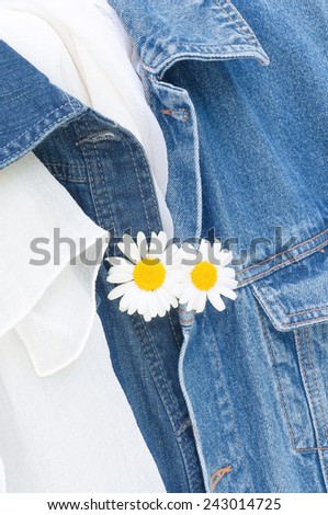 Two white flowers on two jeans jackets, honeymoon, you and me, in love