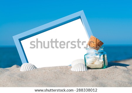 Blank blue picture frame in sandy beach with maritime decoration