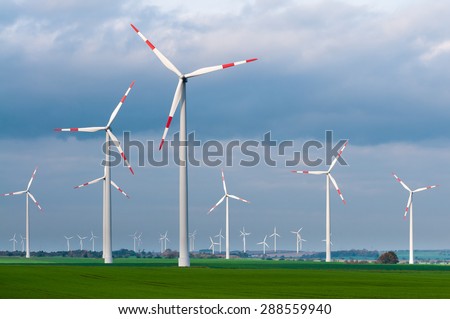 Wind turbines in the open countryside on windy day with dark clouds in the sky; Alternative power generation