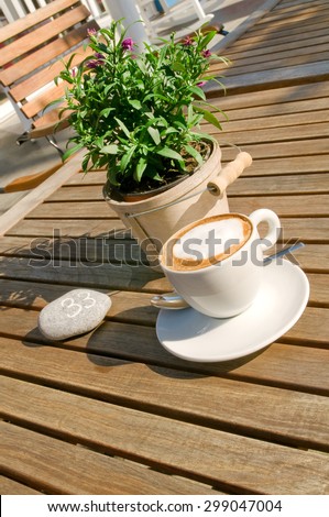 Creamy cappuccino served in a garden restaurant