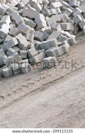 Pile of interlocking paving stones; Building material for road construction or garden design