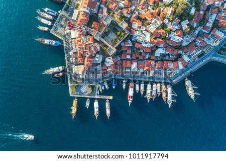 Aerial view of boats, yahts, floating ship and beautiful architecture at sunset in Marmaris, Turkey. Landscape with boats in marina bay, sea, buildings in city. Top view of harbor with sailboat.