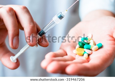 Syringe, pills or capsules, medical injection in hand, palm or fingers. Medicine plastic vaccination equipment with needle. Nurse or doctor. Liquid drug or narcotic. Health care in hospital.