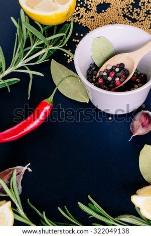 Food spice seasoning ingredients for cooking in cuisine on dark background. Dry powder curry, ginger, cardamon, rosemary, chili. Asian  yellow, green colorful aroma condiment.
