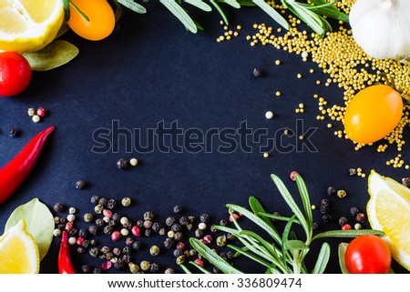 Food spice seasoning ingredients for cooking in cuisine on dark background. Dry powder curry, ginger, chili pepper, rosemary, salt, paprika, saffron. Asian  yellow, green colorful aroma condiment.