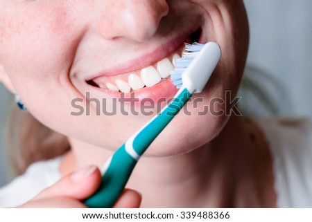 Dental hygiene and care. White toothbrush. Young healthy woman face with beauty smile. Tooth brush. Oral clean, whitening. Beautiful girl. Person healthcare. Female in the morning in bathroom.