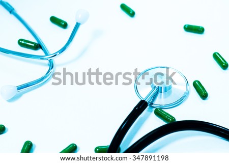 Medical, medicine stethoscope and pills on blue background. Health care or illness. Tablet or drug in hospital or pharmacy. Cardiology heart treatment. Medication prescription for medication, therapy
