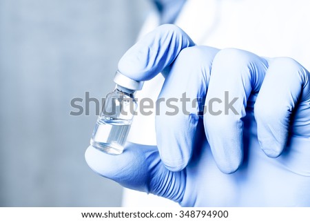 Bottle, ampule, medical injection in hand, palm or fingers. Medicine glass vaccination equipment with needle. Nurse or doctor. Liquid drug or narcotic. Health care in hospital.