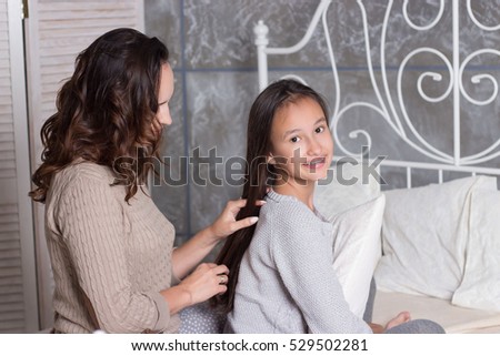 Mom and daughter secretive. Mom and daughter resting on the bed. Good morning. Cozy Fall. Winter.